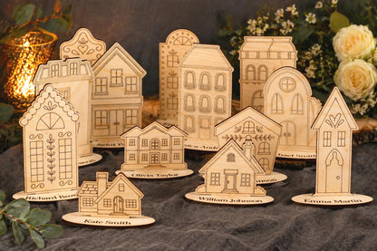 A collection of wooden houses or buildings, each with unique designs and decorations, arranged on a dark surface. The houses appear to be made of wood and are placed on small platforms or stands.