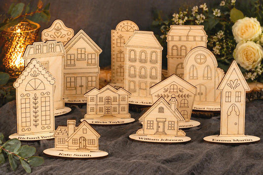 A collection of wooden houses or buildings, each with unique designs and decorations, arranged on a dark surface. The houses appear to be made of wood and are placed on small platforms or stands.