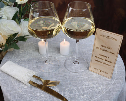 two glasses of wine on a table with a sign