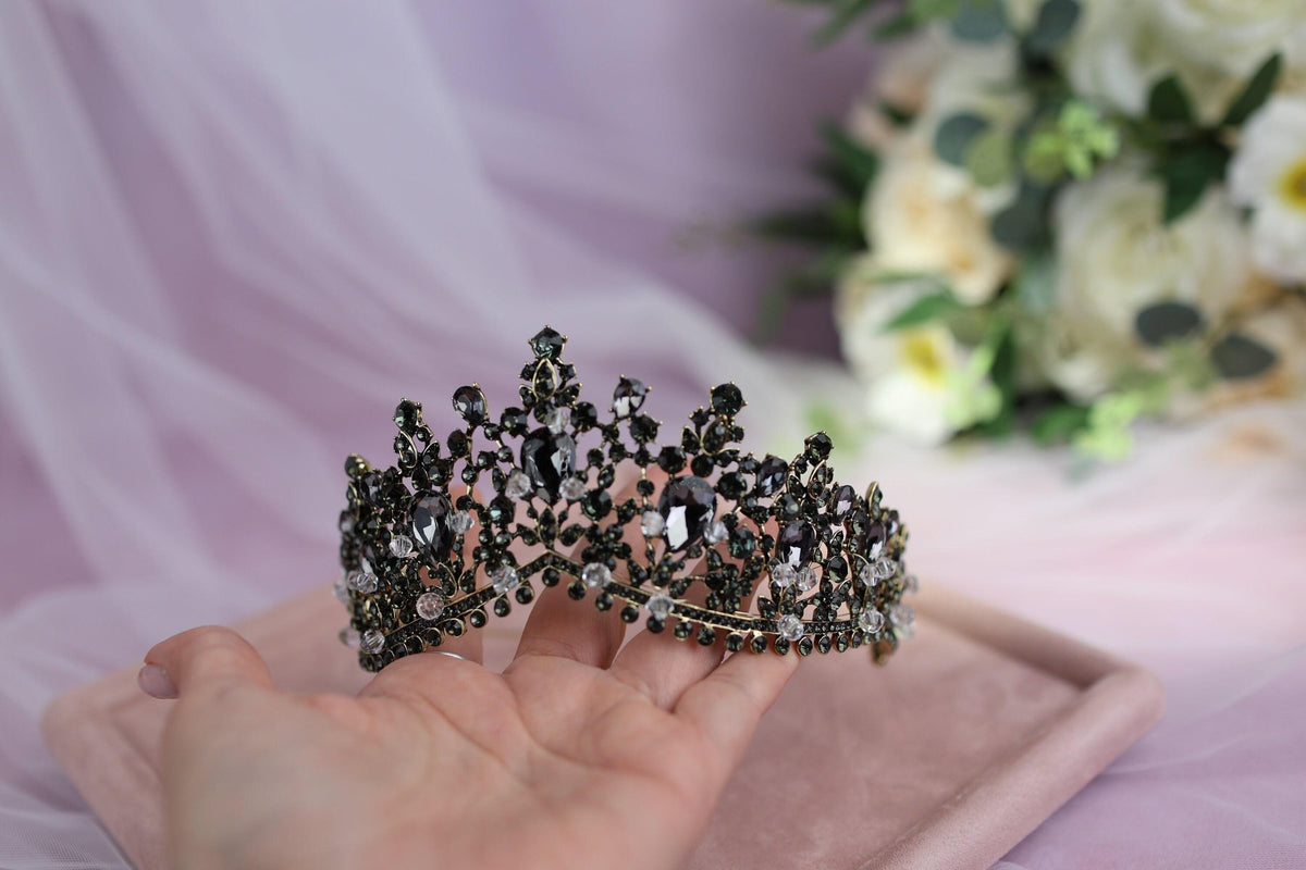 a person holding a tiara in their hand