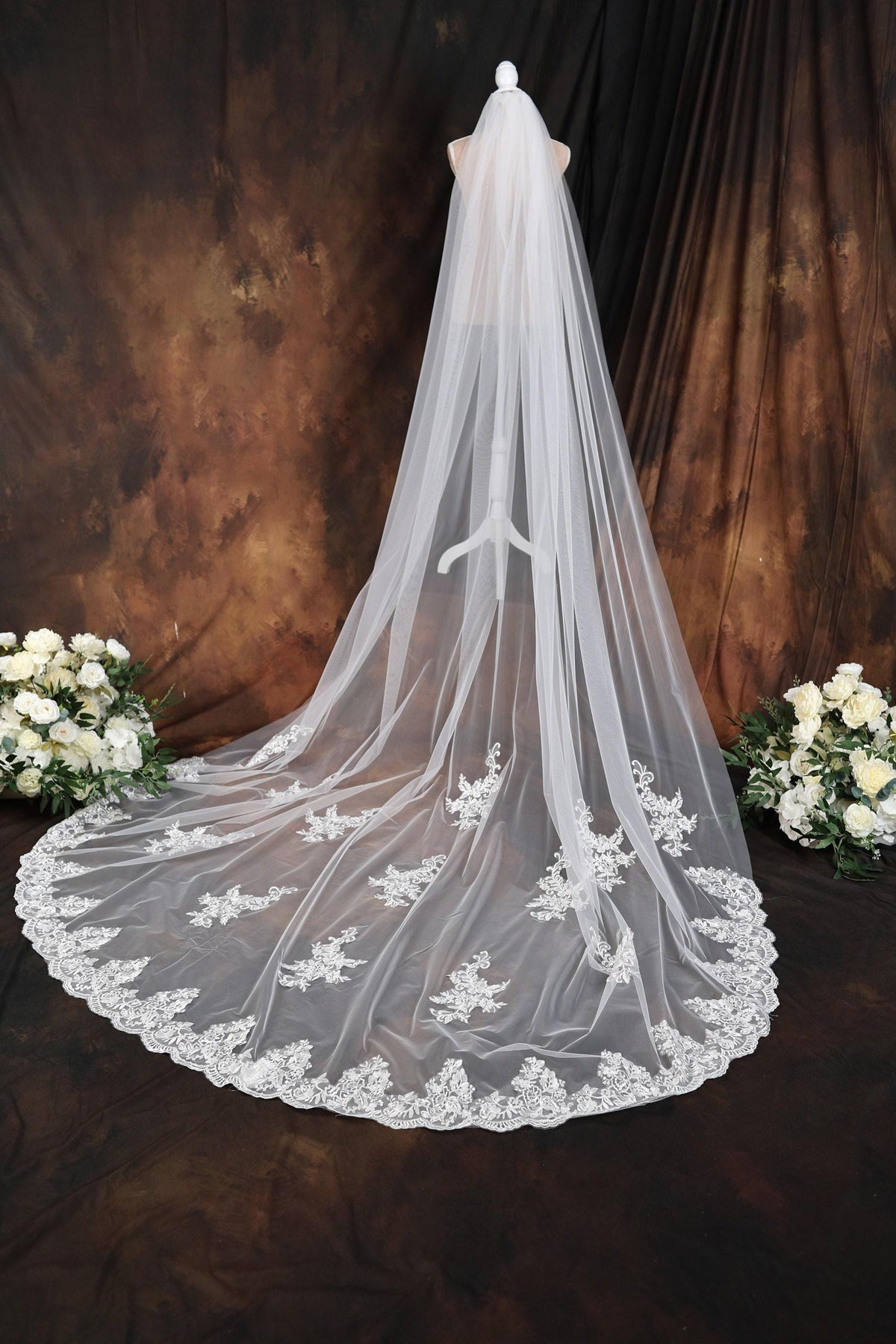 a wedding veil with flowers on a table