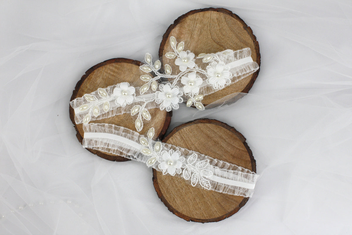 a pair of wooden sandals with white flowers on them