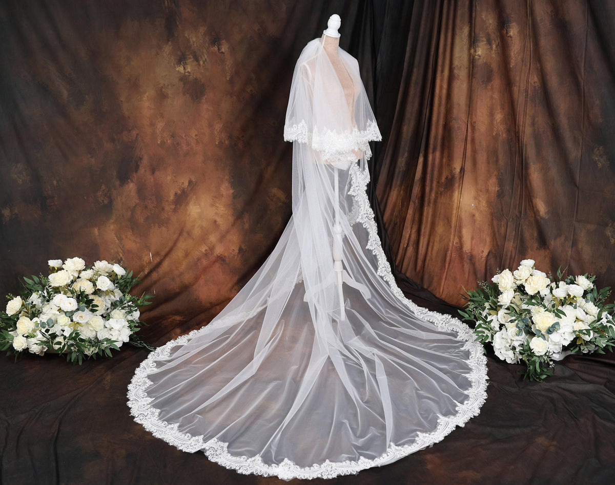 a wedding dress with a veil on a mannequin