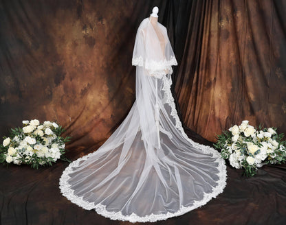 a wedding dress with a veil on a mannequin