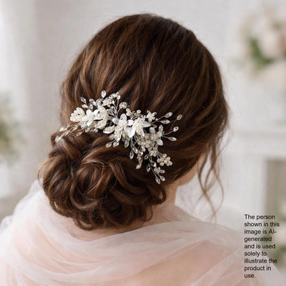 a woman's back view with her hair styled in a bun, adorned with a decorative hair accessory featuring white flowers and leaves.