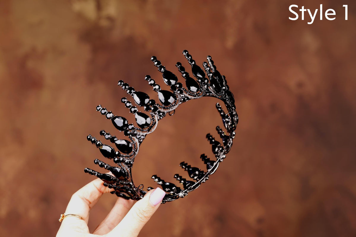 a hand holding a black and white tiara