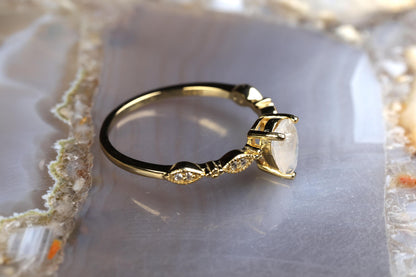 a diamond ring sitting on top of a rock