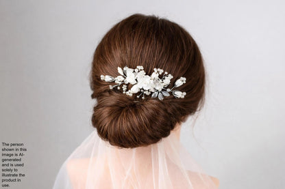 A close-up view of a woman's hair with a decorative hair accessory featuring white flowers and leaves.