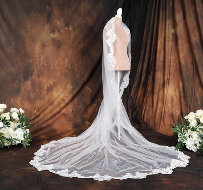 a wedding dress on a mannequin in front of a backdrop