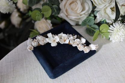 a white flower crown sitting on top of a blue plate