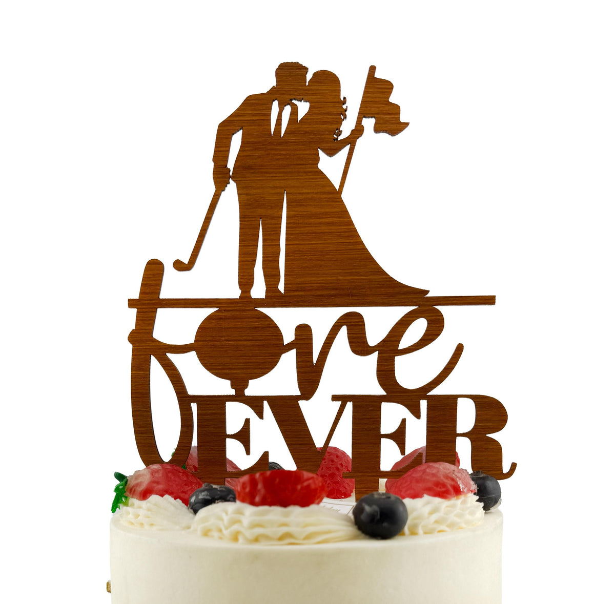 A wooden wedding cake topper with a silhouette of a bride and groom, and the word "love ever" written on it.