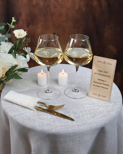 two glasses of wine on a table with a menu