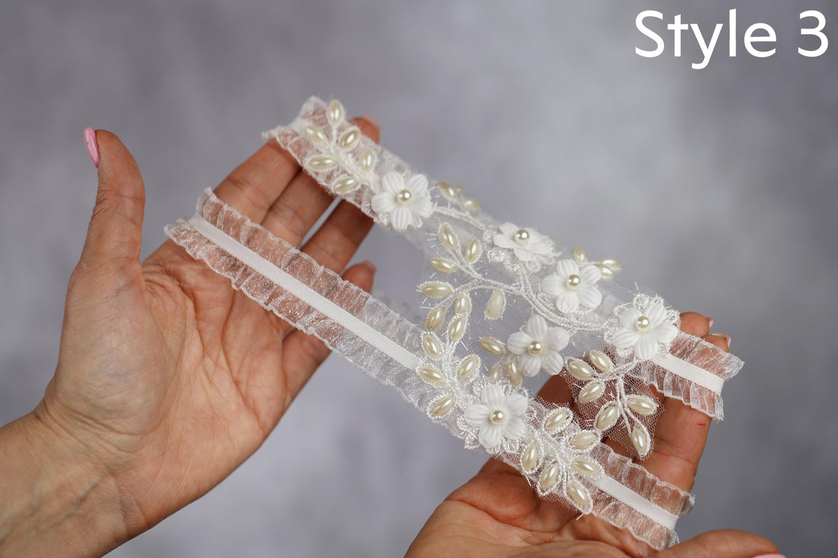 a pair of hands holding a piece of lace
