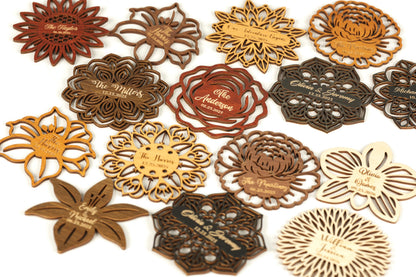a collection of wooden coasters or magnets with various floral designs and text.