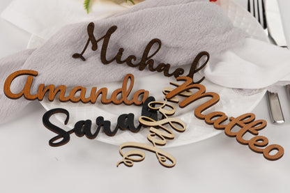 a close-up of a table setting with several personalized nameplate holders.