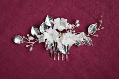 a hair comb with flowers and leaves on it