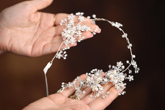 a woman is holding a tiara in her hands