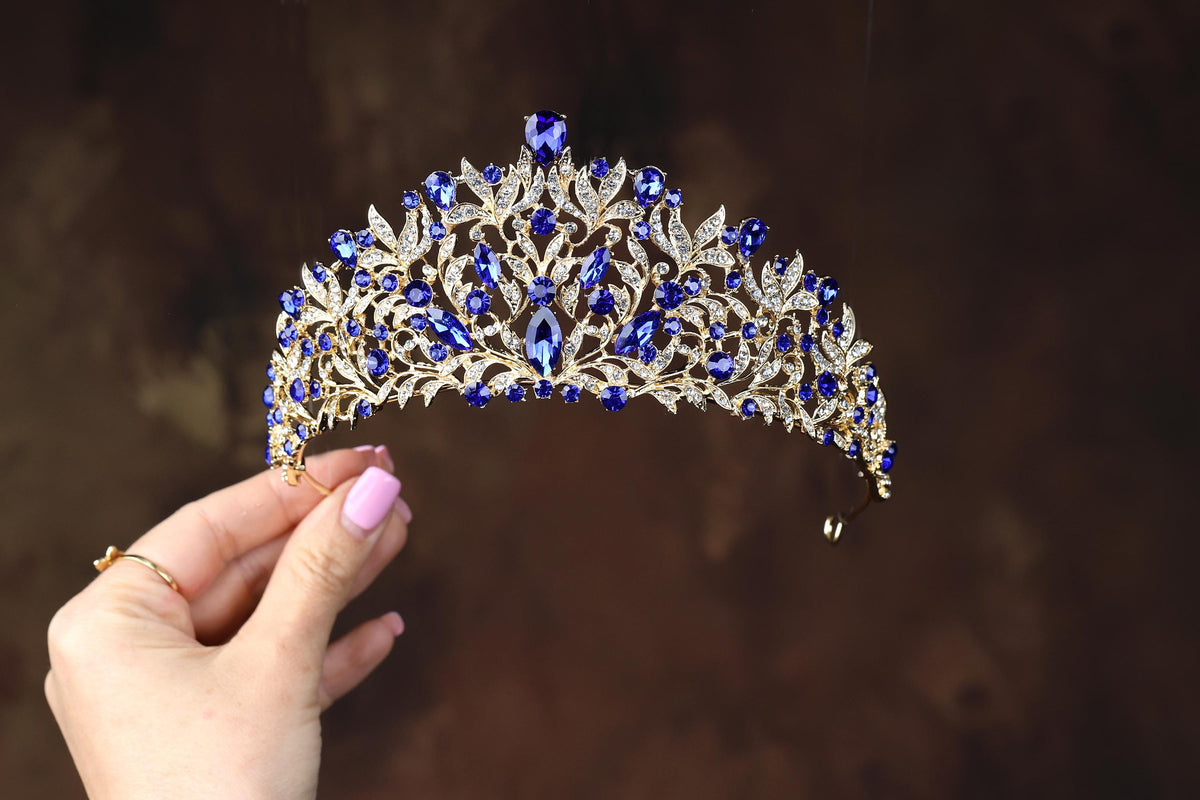 a woman holding a tiara in her hand