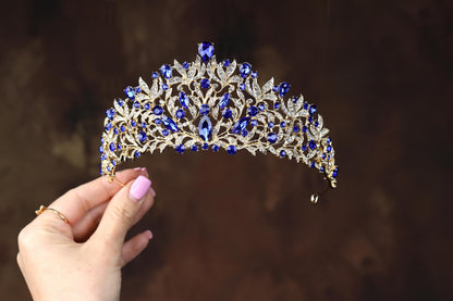 a woman holding a tiara in her hand