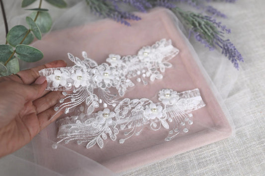 a hand is holding a piece of white lace