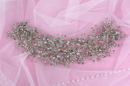 a close up of a necklace on a pink background