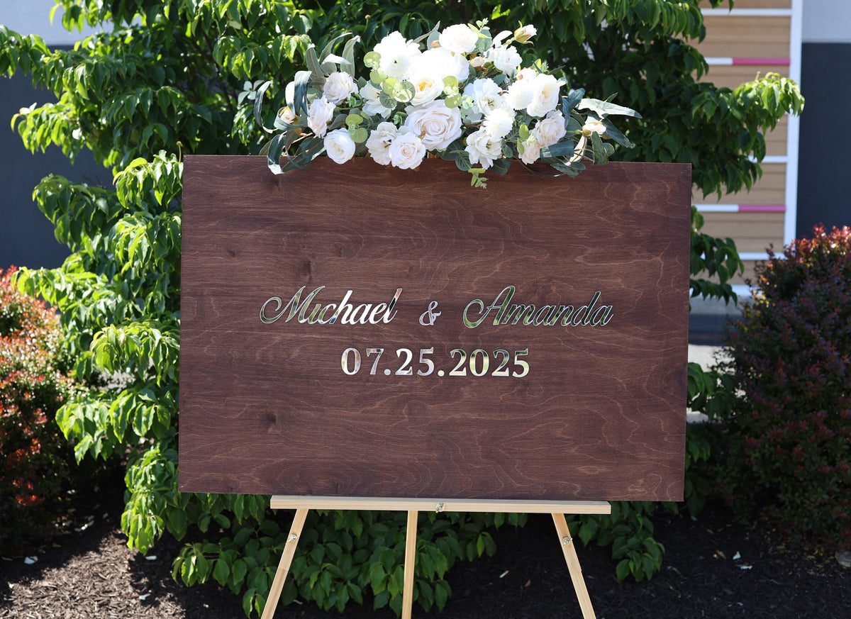 a wooden sign with a bouquet of flowers on top of it