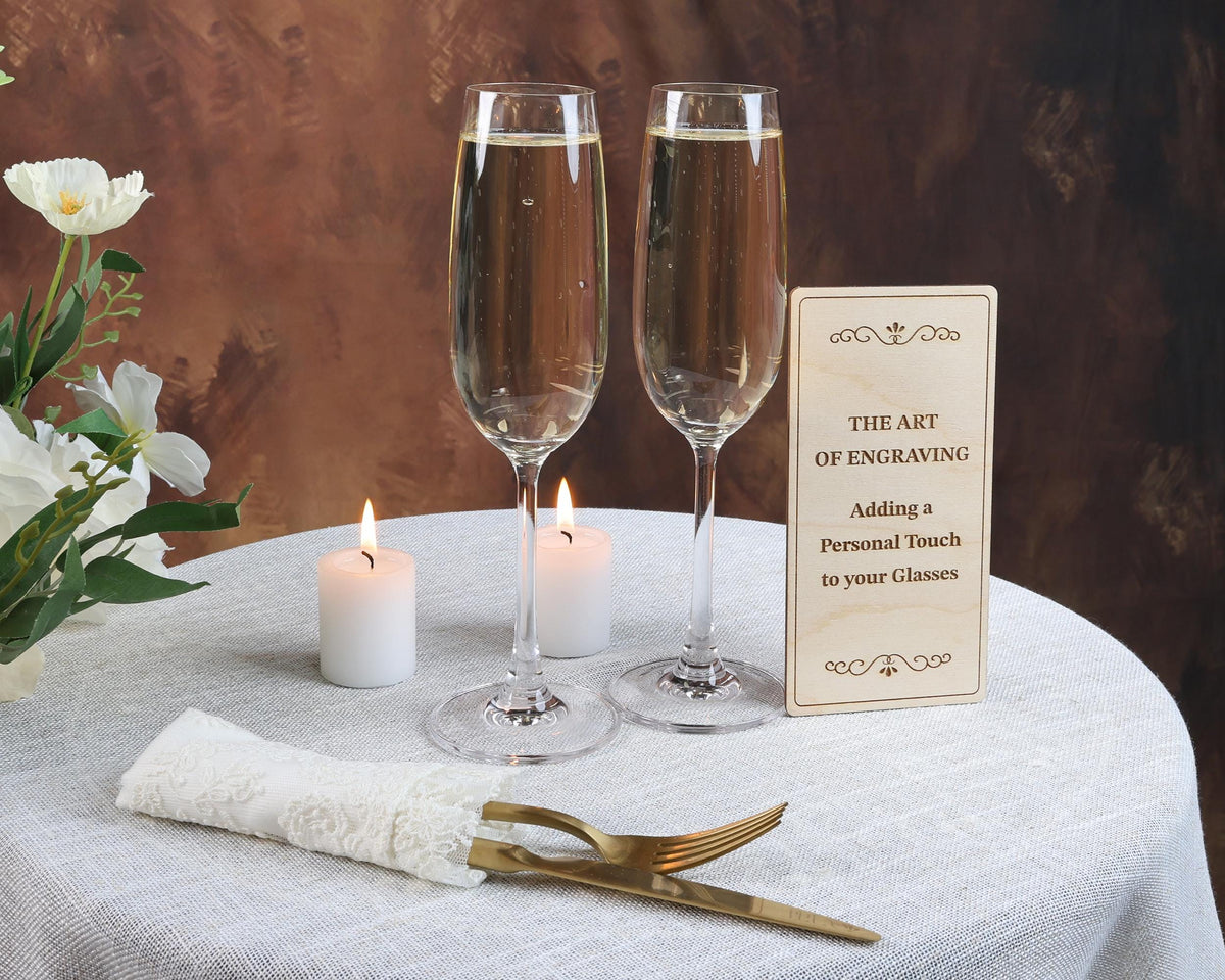a table with two glasses of wine and a sign
