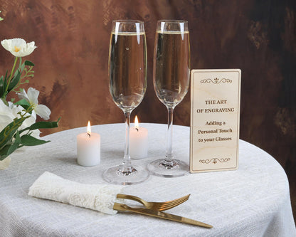 a table with two glasses of wine and a sign