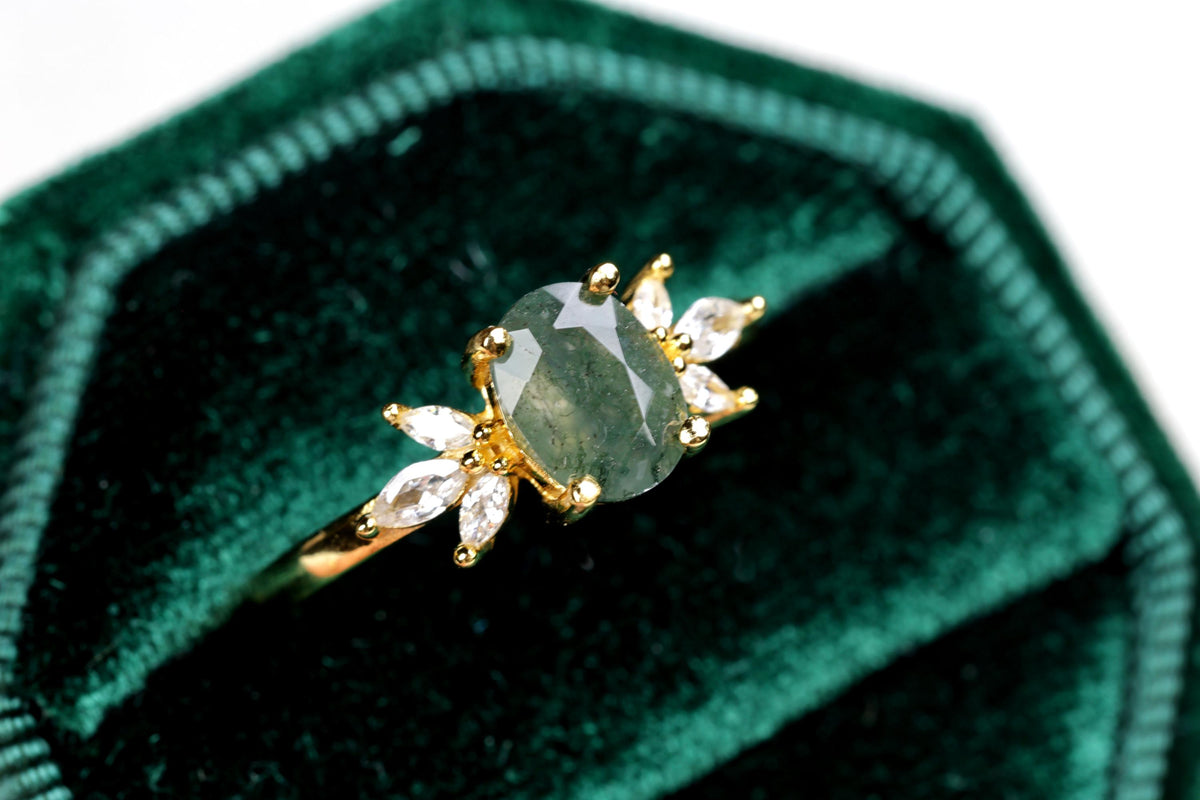 a close up of a ring on a velvet case