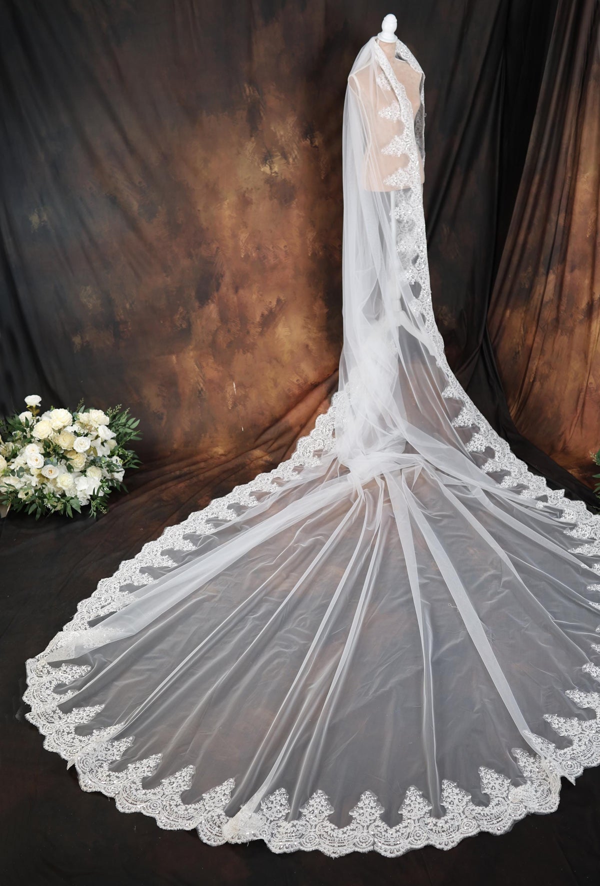 a white wedding veil with a lace edge