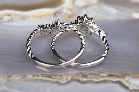 a couple of silver rings sitting on top of a table