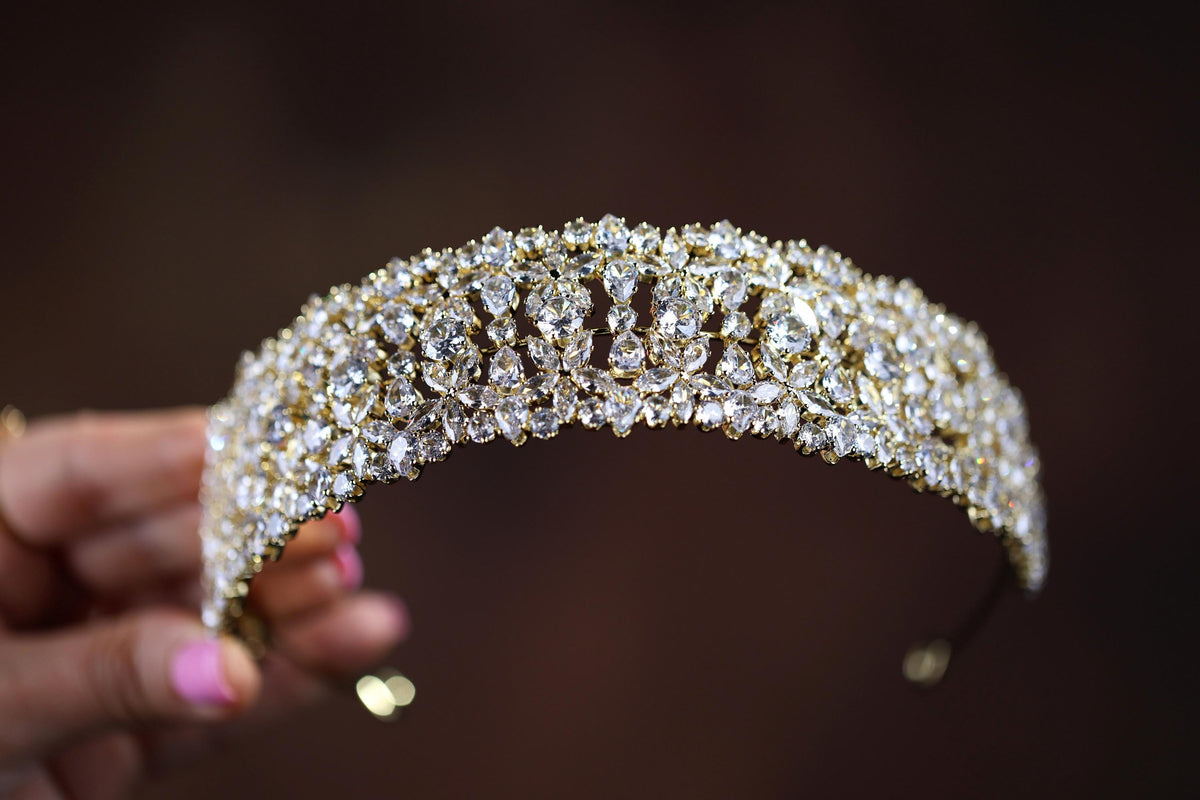 a close up of a person holding a tiara
