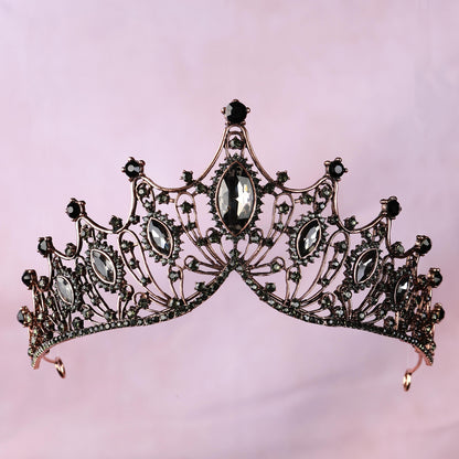 a tiara with a black diamond on top of it