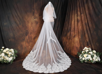 a wedding dress with a veil on a mannequin