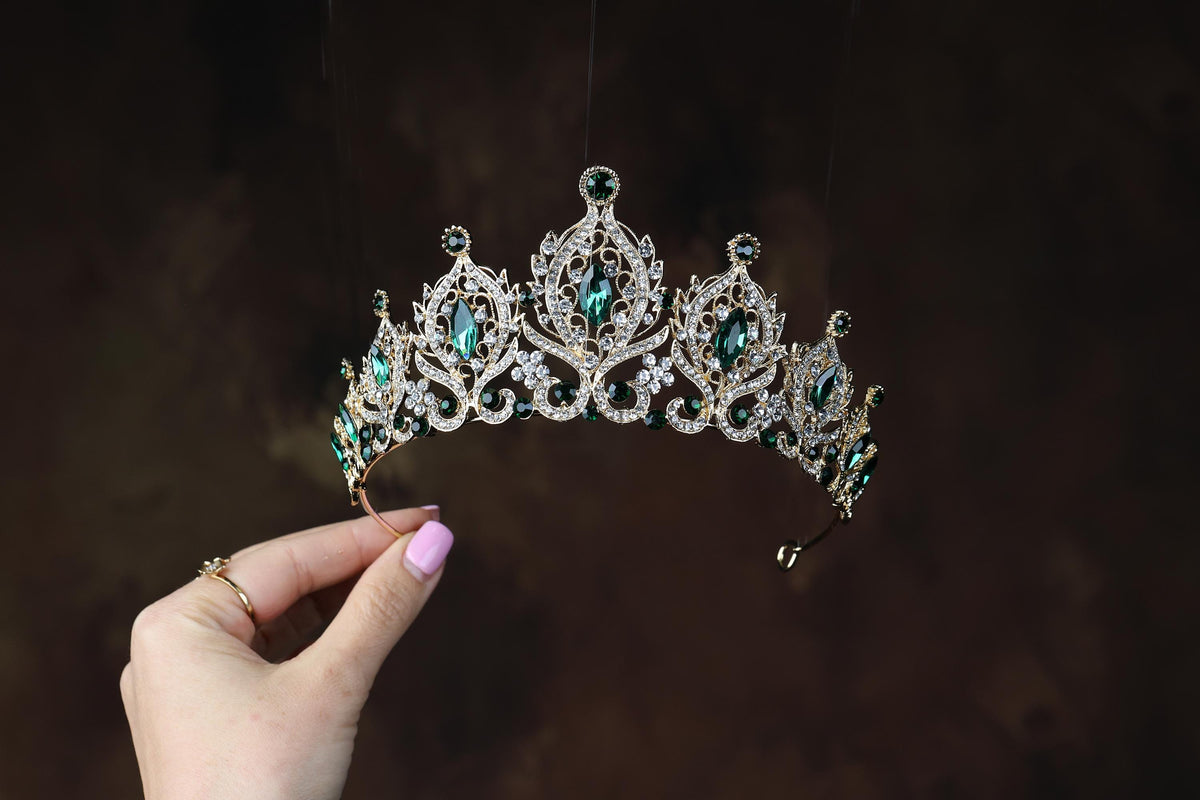 a woman holding a tiara in her hand