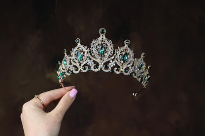 a woman holding a tiara in her hand
