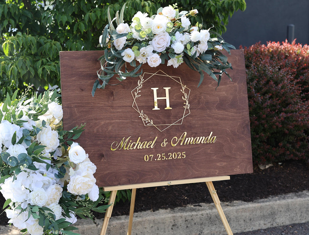 a wooden sign with a floral arrangement on top of it