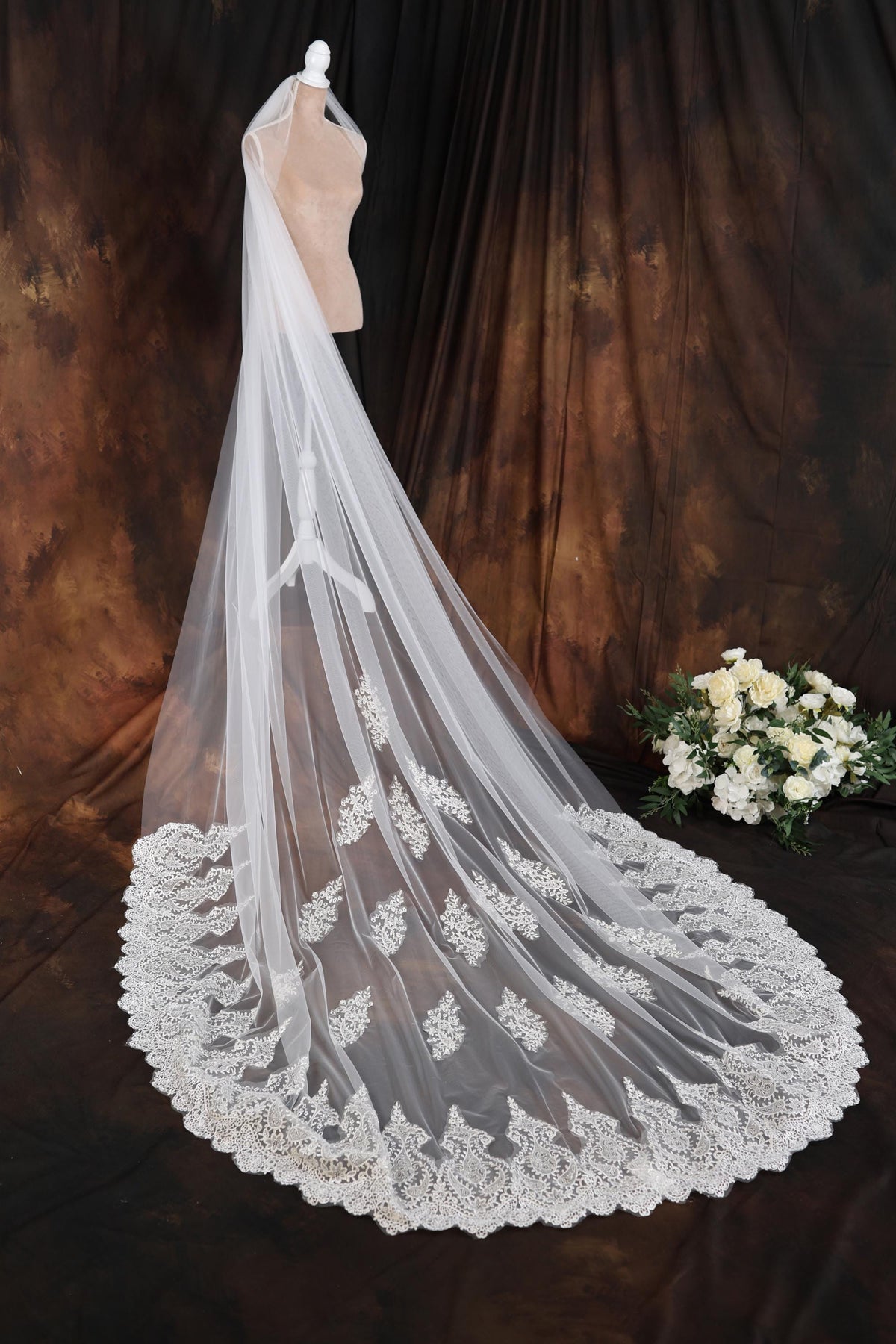 a wedding veil on a mannequin with flowers