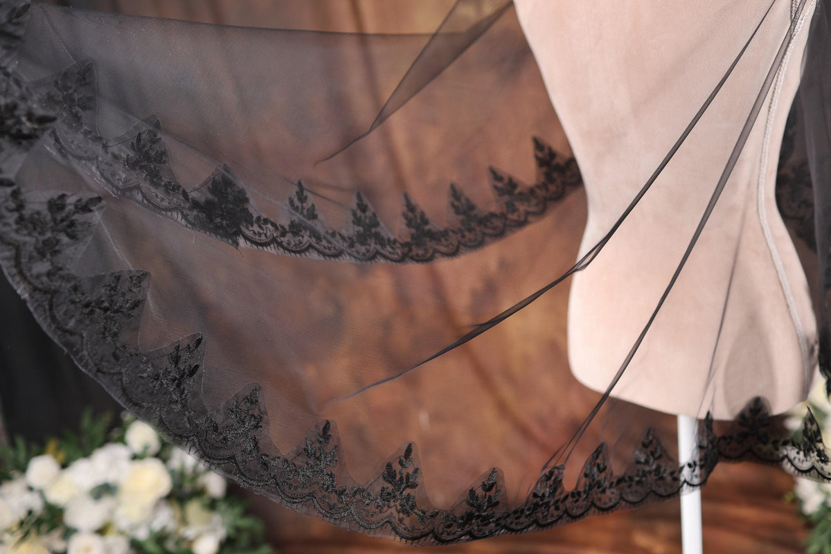 a dress on a mannequin next to a flower arrangement