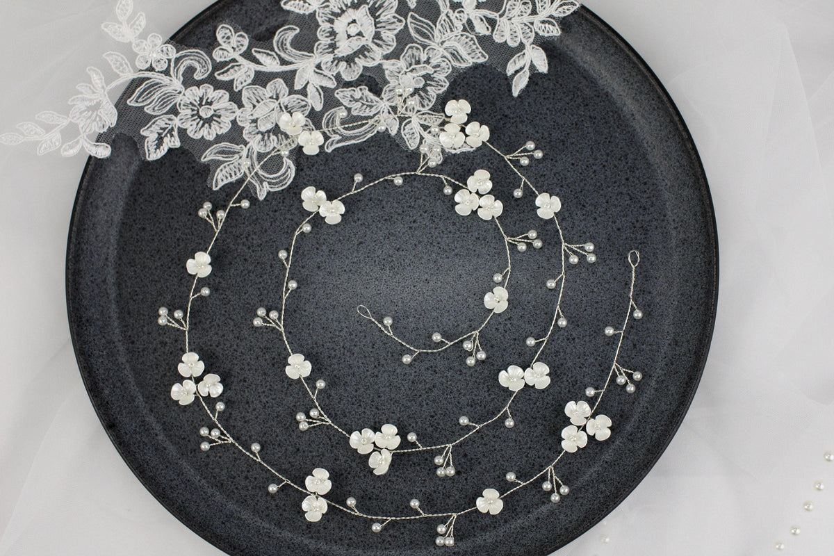 a black plate with white flowers on it