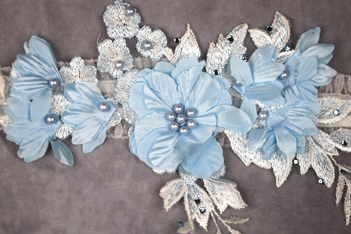 a close up of a blue flower on a gray background