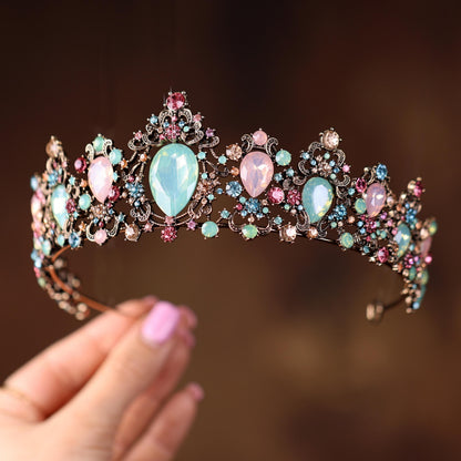 a woman holding a tiara in her hand