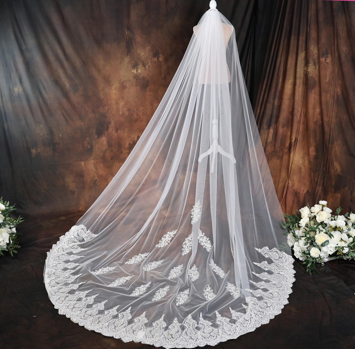 a white wedding veil with flowers on a table
