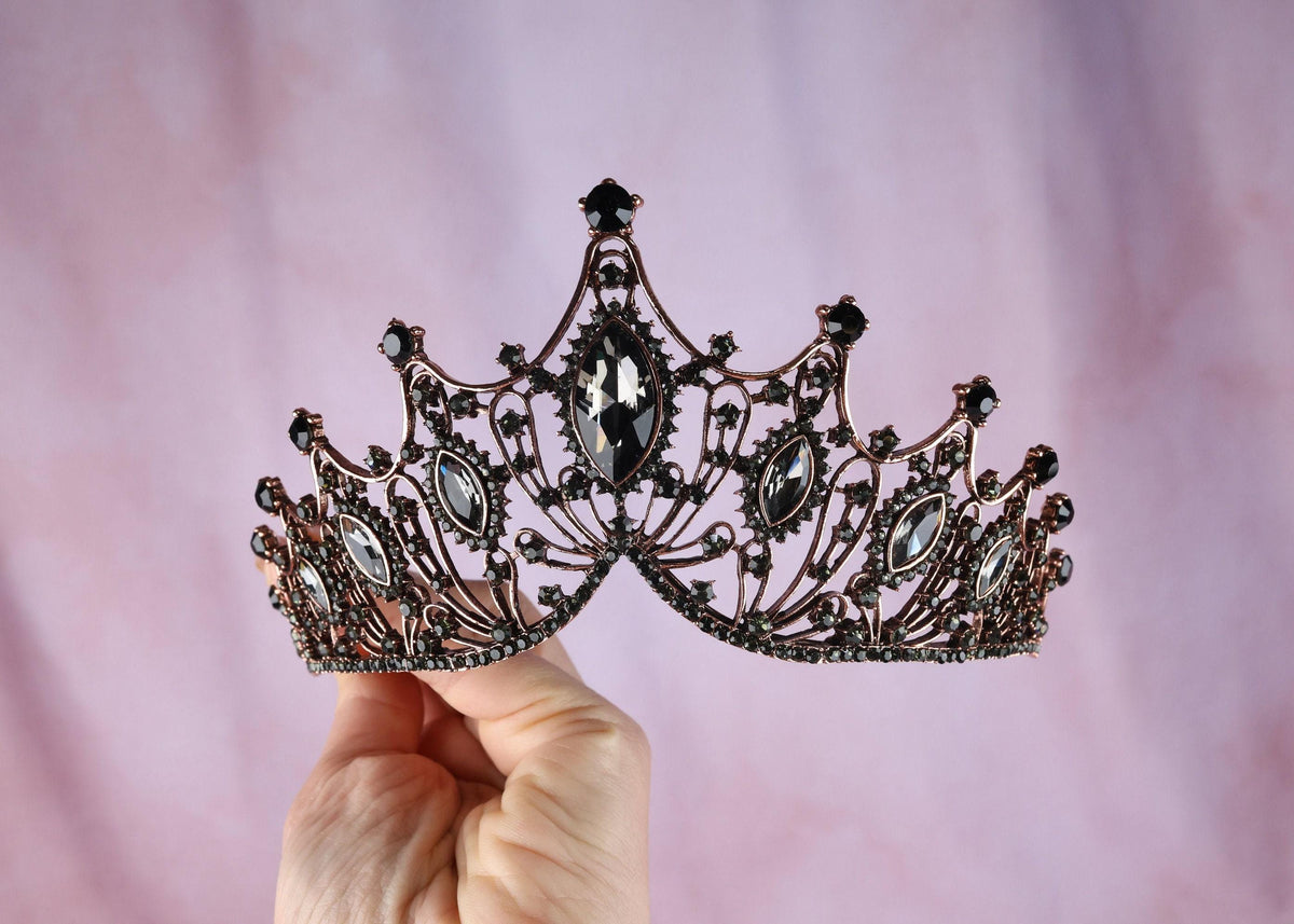 a person holding a tiara in their hand