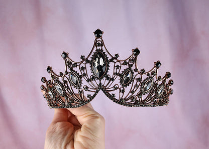 a person holding a tiara in their hand