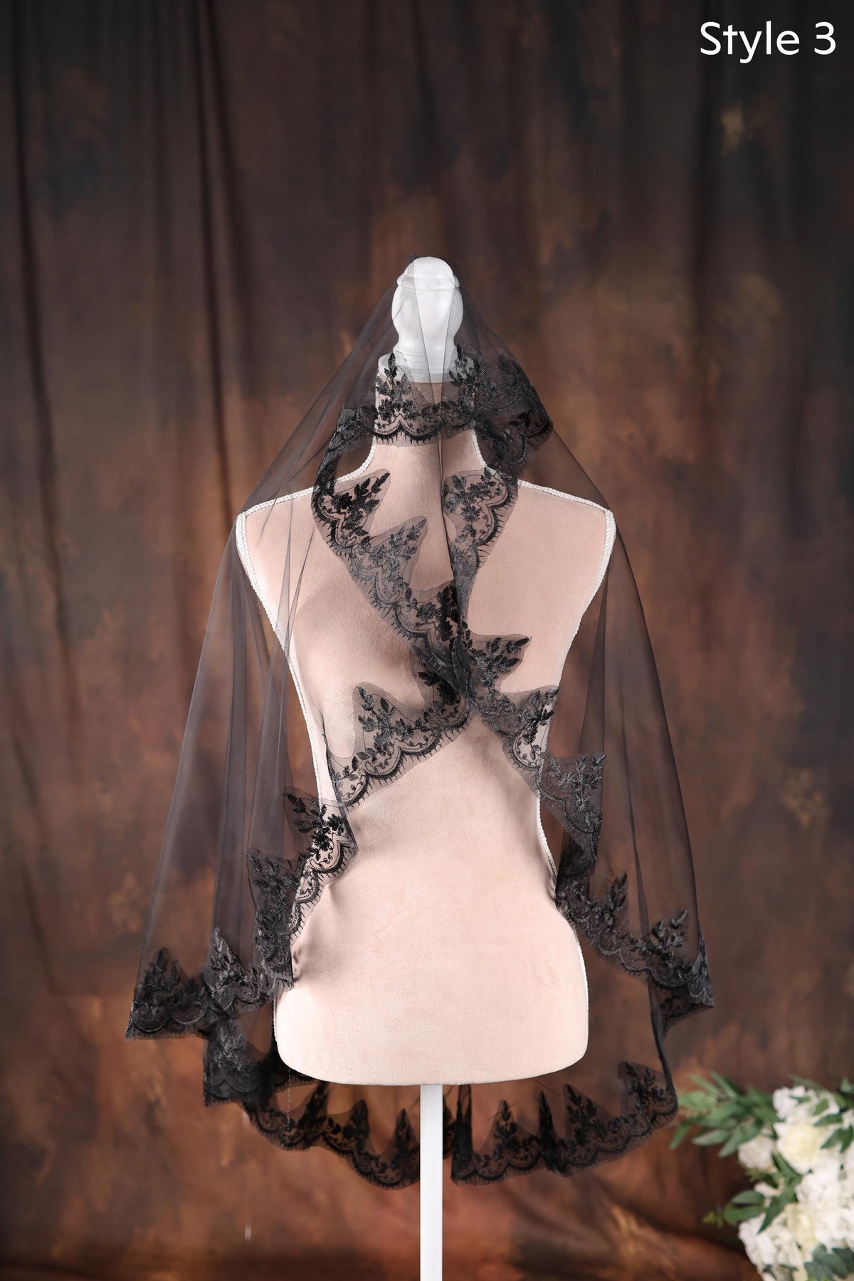 a mannequin with a black veil on top of it