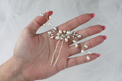 a woman's hand with a bunch of pearls on it