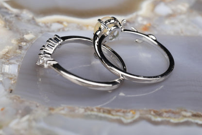 a couple of silver rings sitting on top of a rock