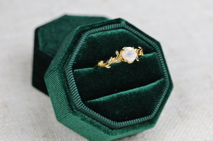a close up of a ring in a velvet box