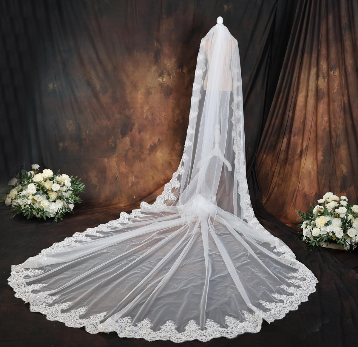 a wedding veil with a bouquet of white flowers